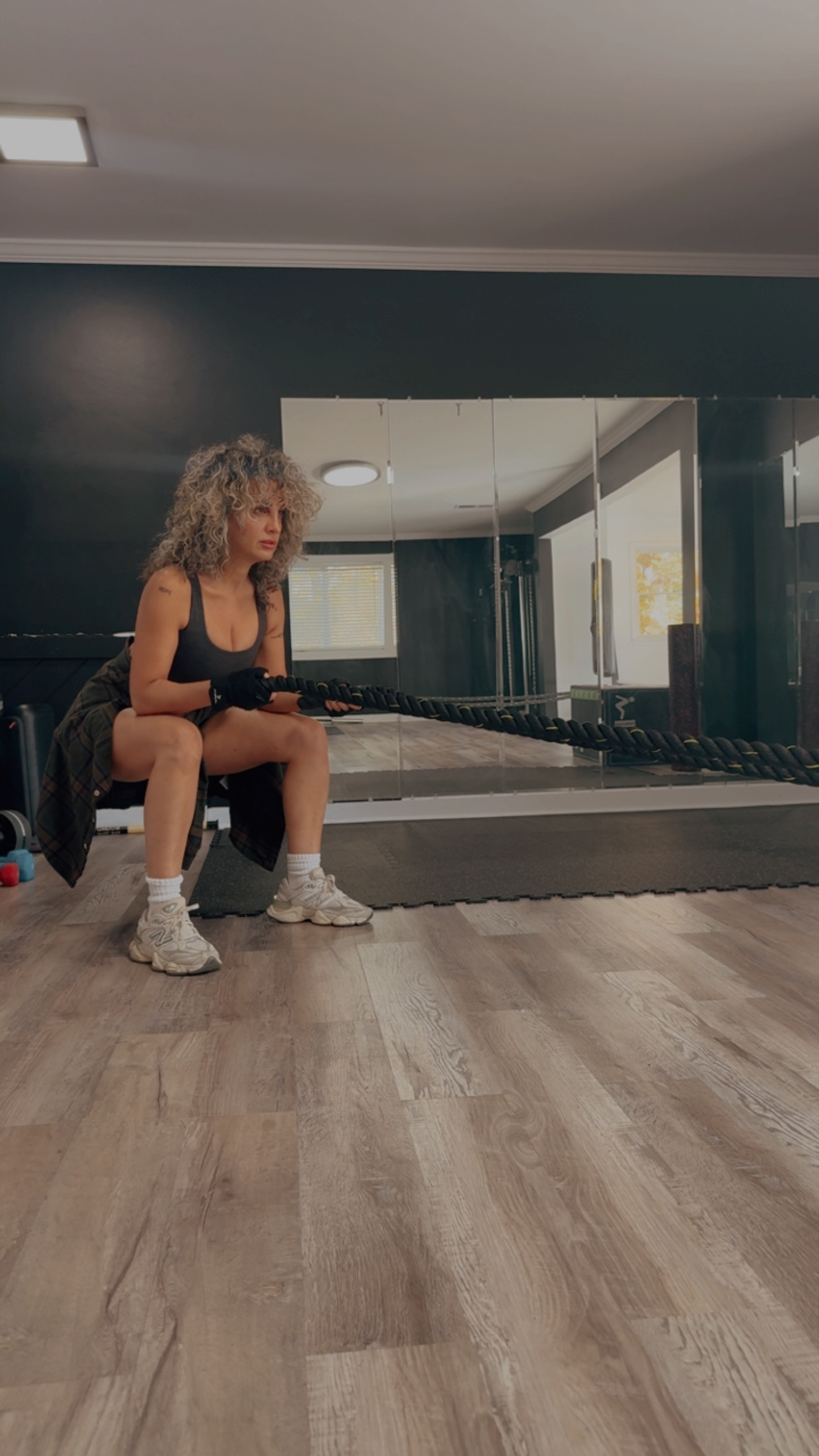 Osi training with battle ropes in her private studio